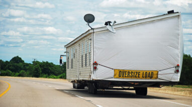 Modular home being transported along interstate highway - Affordable Washington Manufactured Home Insurance