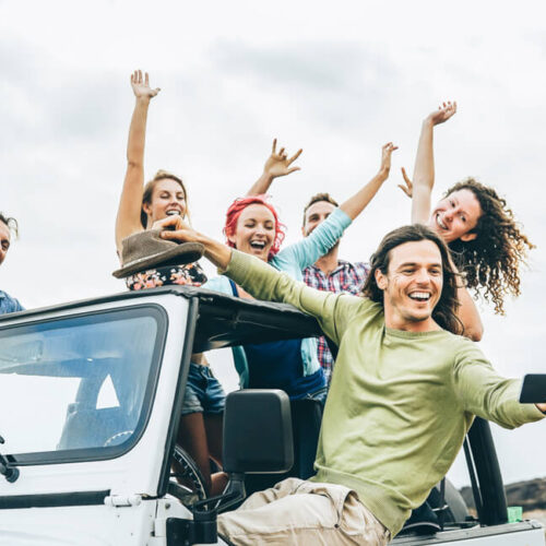 Group of Generation Z friends on a convertible truck, having fun and taking a photograph - Vern Fonk, affordable car insurance in Washington
