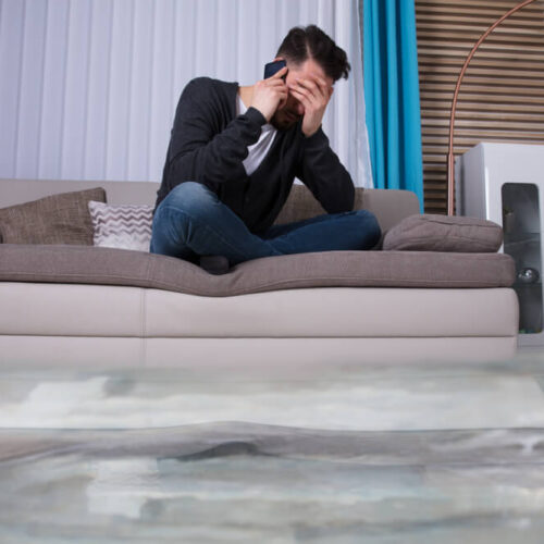 Man watching how his house is being flooded